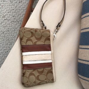 Coach corner zip wristlet, clean insides, zipper works well, fabric and leather.